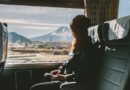 mikro putovanja, putovanja, Enjoying travel. Young pretty woman traveling by the train from sitting near the window and looking mountain Fuji. vintage filter. Travel concept