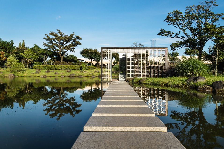 99616437 - path over lake with wall in middle of lake in public park in seogwipo, jeju island, south korea